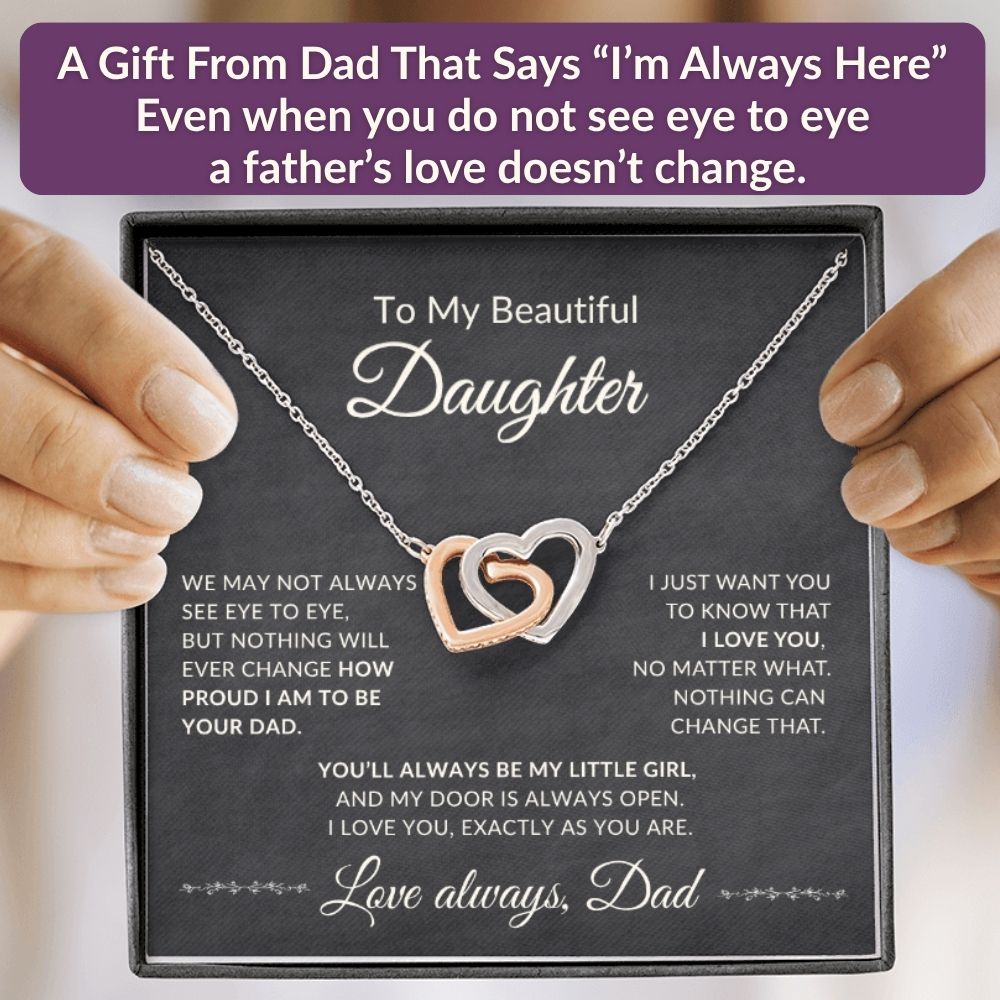 Promotional graphic with the heading A Gift From Dad That Says I'm Always Here, showing an open gift box with the interlocking hearts necklace and a heartfelt message card.