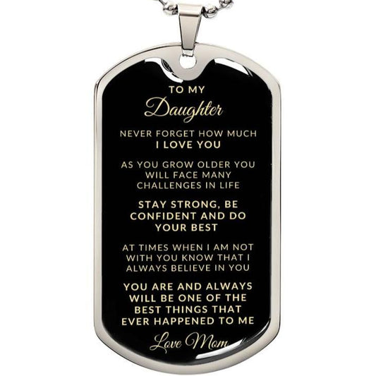 A silver dog tag necklace with a personal message engraved on it, attached to a chain.