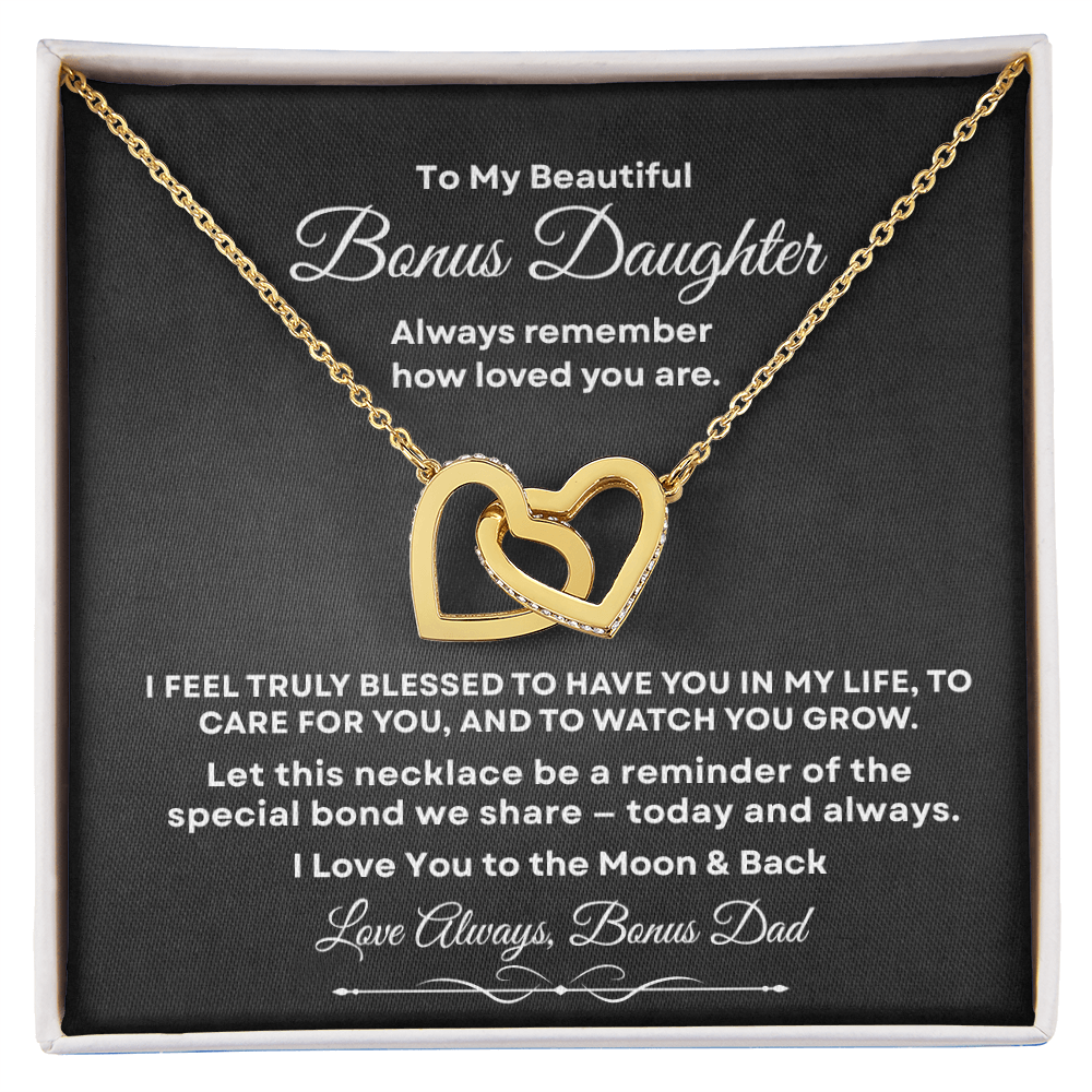 Interlocking hearts necklace in 18K yellow gold finish resting inside a gift box on a message card for bonus daughter titled To My Beautiful Bonus Daughter from Bonus Dad.
