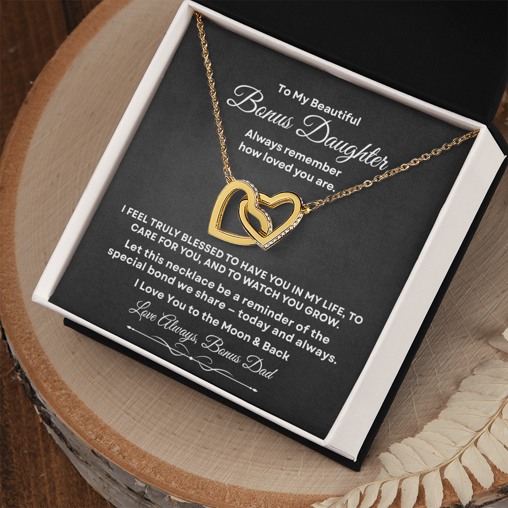 Interlocking hearts necklace in 18K yellow gold finish displayed inside a gift box on a message card for bonus daughter reading To My Beautiful Bonus Daughter.