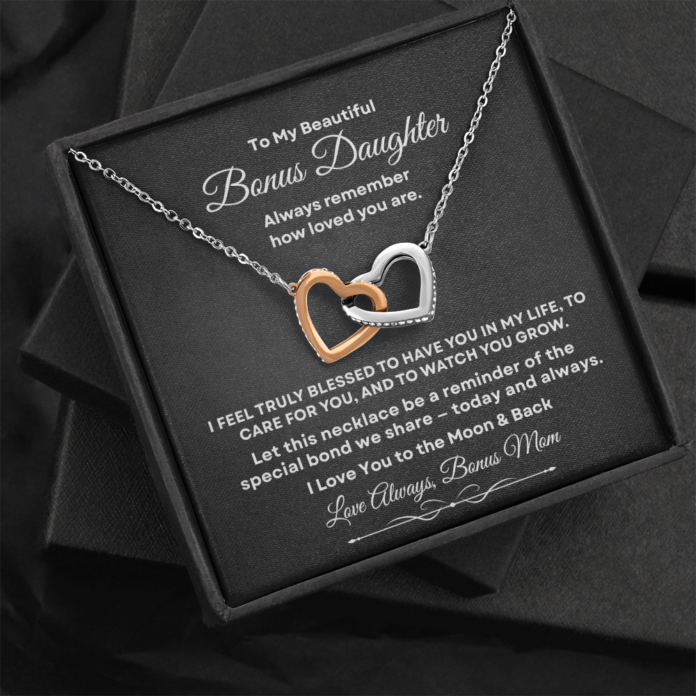 Interlocking hearts necklace with rose gold and silver finish resting inside a black gift box on a message card for bonus daughter titled To My Beautiful Bonus Daughter.