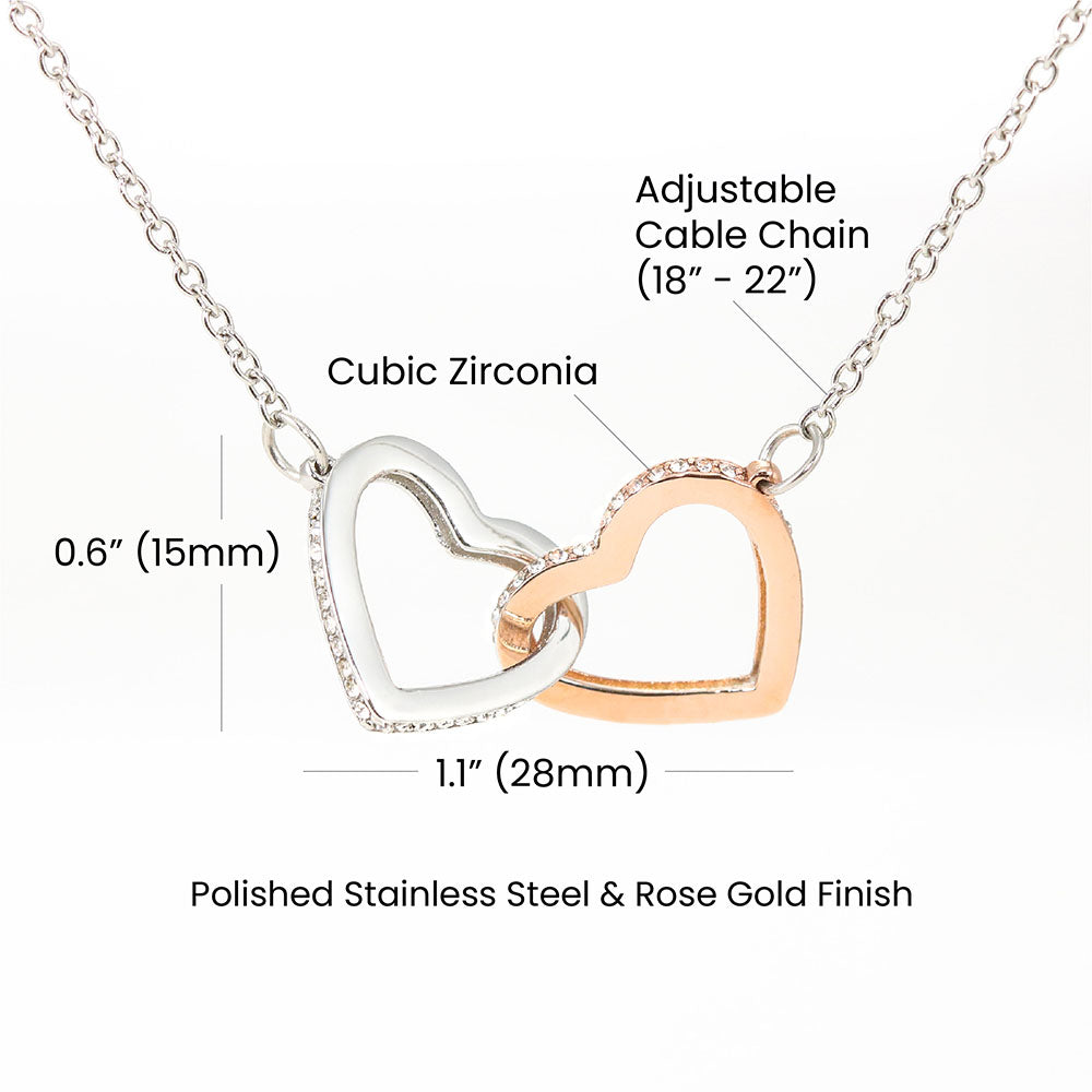 Product specifications graphic for interlocking hearts necklace showing an adjustable 18 to 22 inch cable chain, cubic zirconia details, 0.6 inch by 1.1 inch pendant dimensions, and polished stainless steel with rose gold finish.