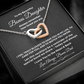 Interlocking hearts necklace with rose gold and silver finish resting inside a black gift box on a message card for bonus daughter titled To My Beautiful Bonus Daughter.