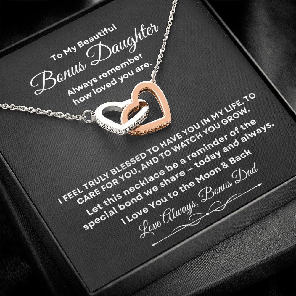 Interlocking hearts necklace with rose gold and silver finish resting inside a black gift box on a message card for bonus daughter titled To My Beautiful Bonus Daughter.
