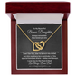 Interlocking hearts necklace in 18K yellow gold finish resting inside a mahogany-style luxury gift box with built-in LED light on a message card for bonus daughter titled To My Beautiful Bonus Daughter from Bonus Dad.