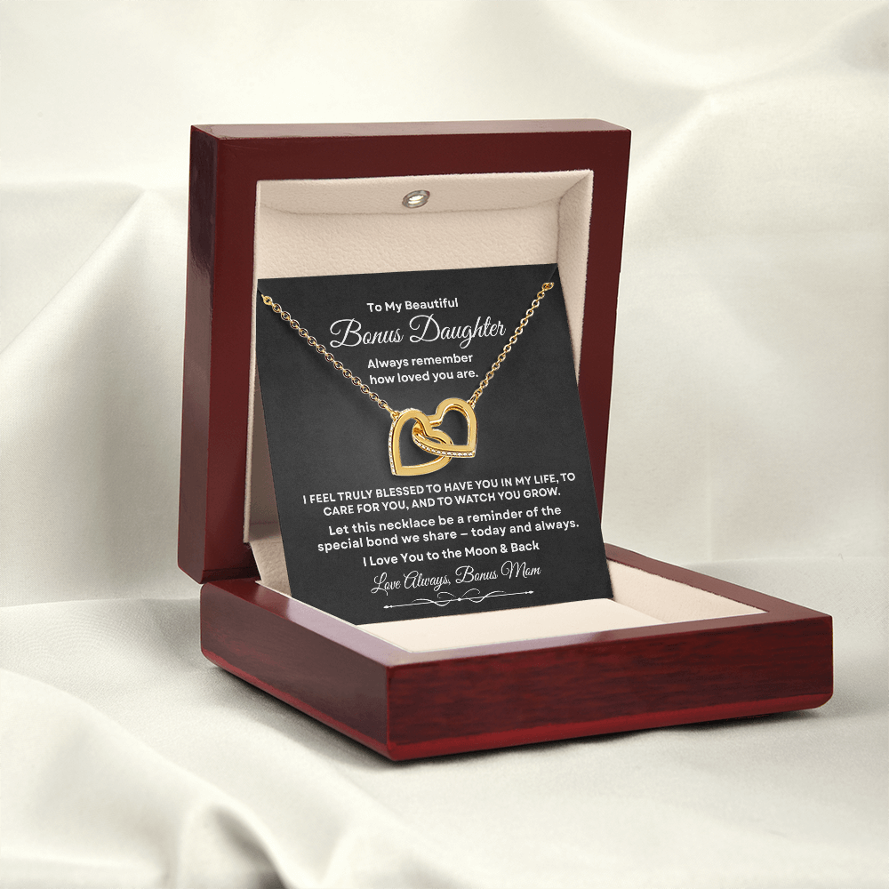 Interlocking hearts necklace in 18K yellow gold finish displayed inside a mahogany luxury gift box with built-in LED light on a message card for bonus daughter.