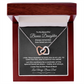 Interlocking hearts necklace in silver and rose gold resting inside a mahogany-style luxury gift box with built-in LED light on a message card for bonus daughter titled To My Beautiful Bonus Daughter from Bonus Dad.