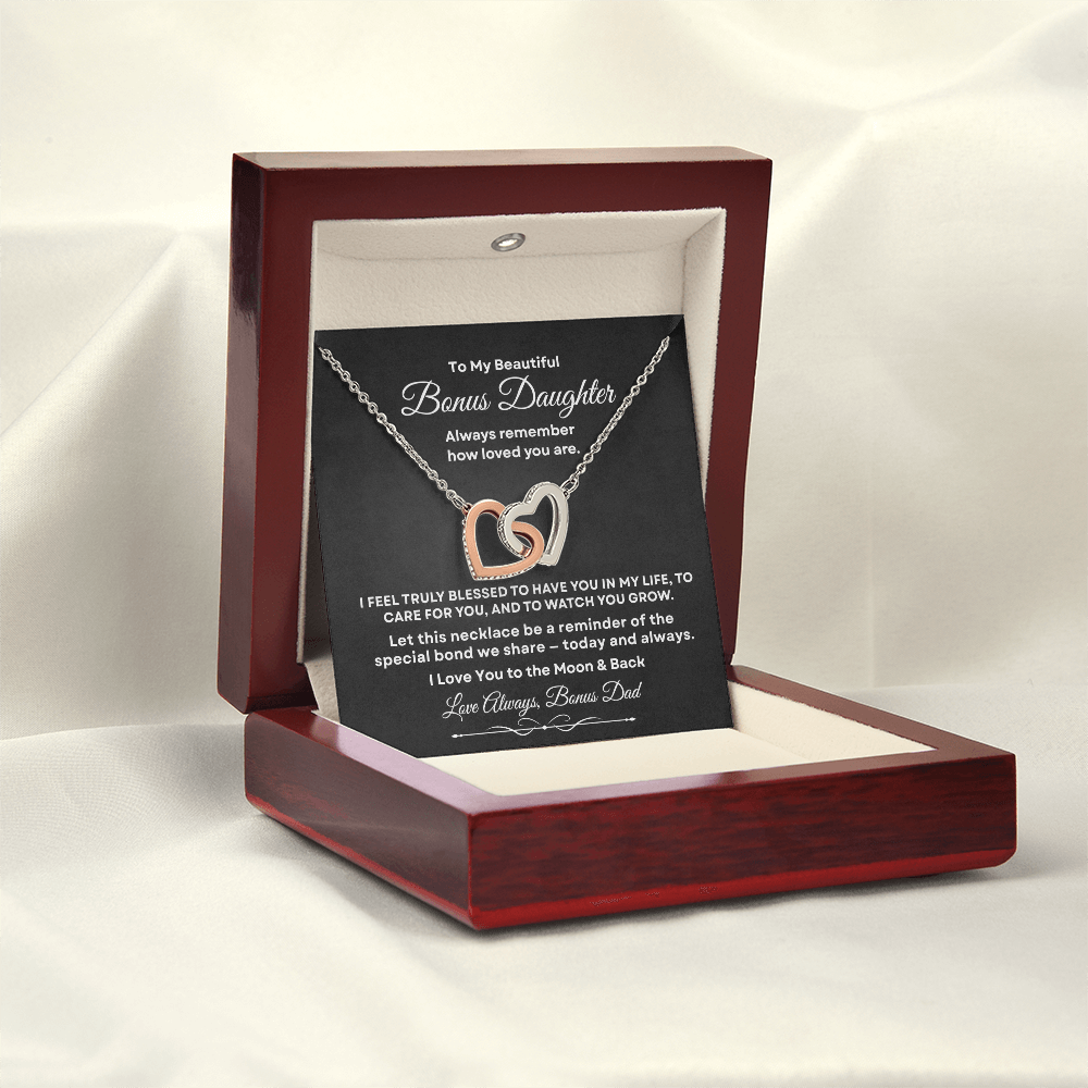 Interlocking hearts necklace in 18K yellow gold finish displayed inside a mahogany luxury gift box with built-in LED light on a message card for bonus daughter.