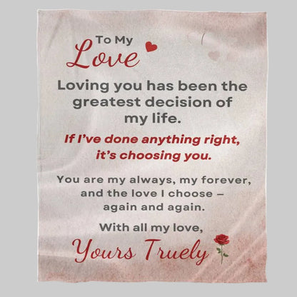 Blanket with romantic message and heart designs on a light gray background