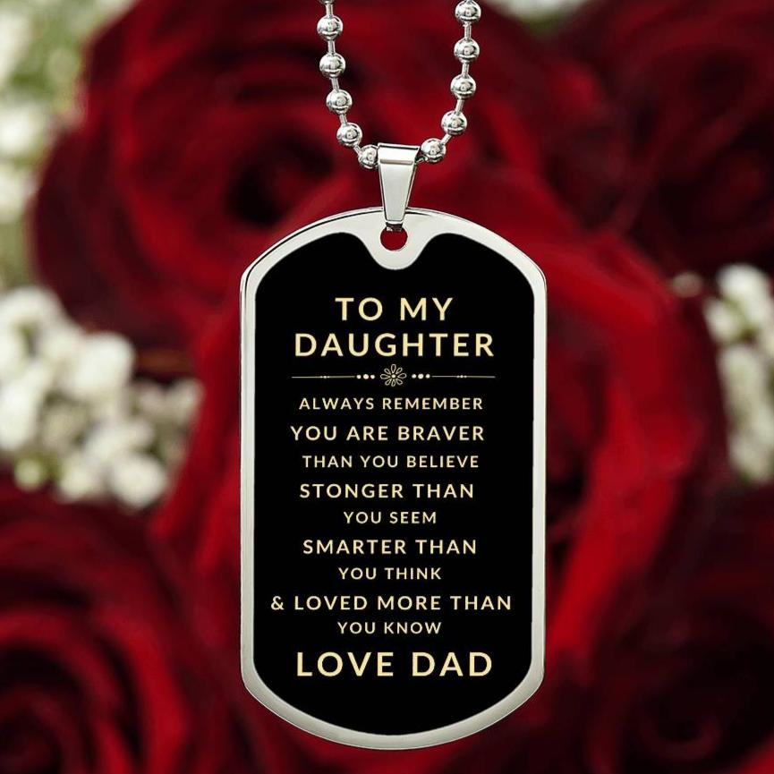 Personalized silver dog tag necklace pendant with inspirational message to daughter from dad over background of red roses.