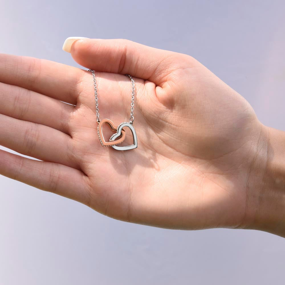 Interlocking hearts necklace close up, meaningful daughter gift from mom