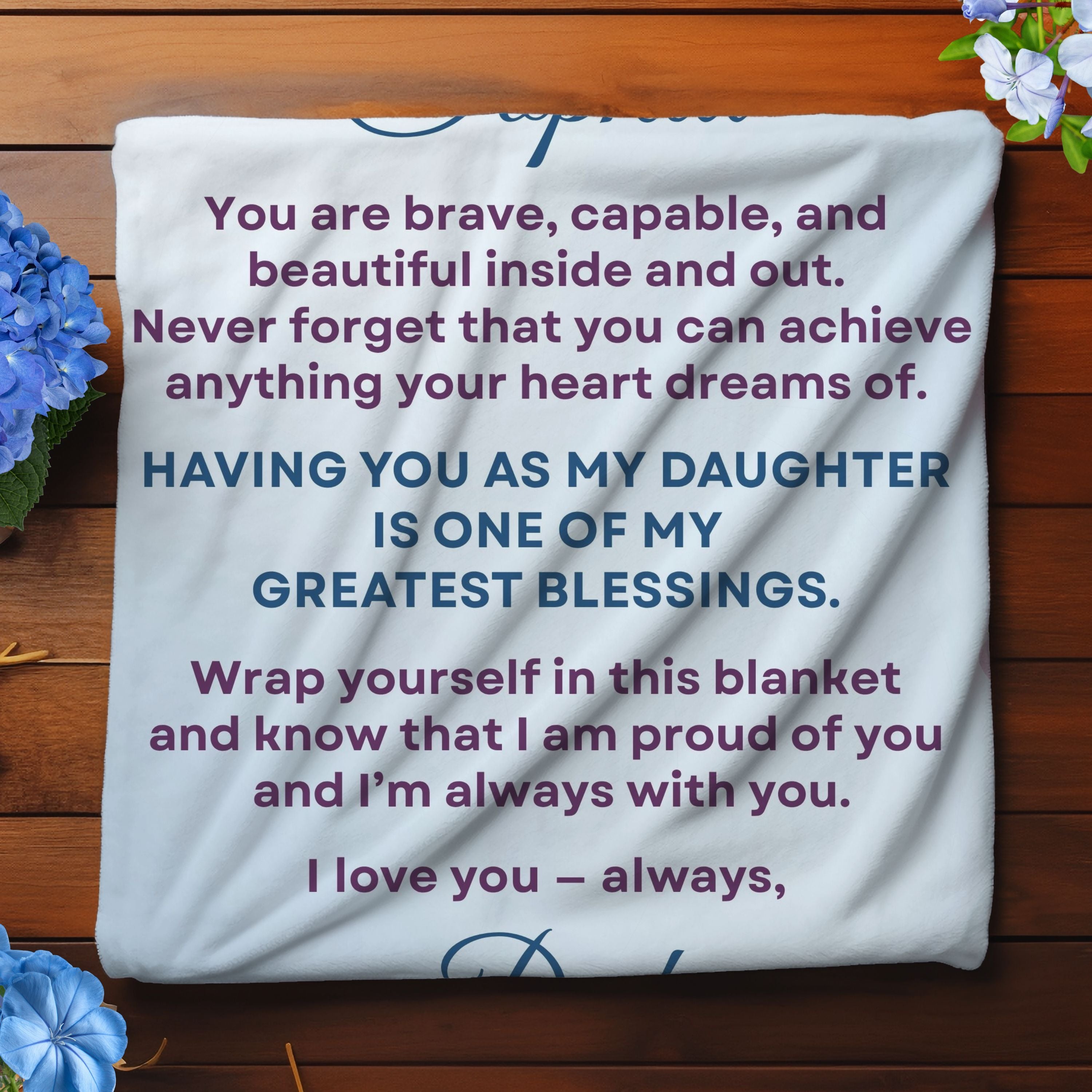  Folded jersey fleece blanket showing soft texture, blue floral design, and personalized message. 