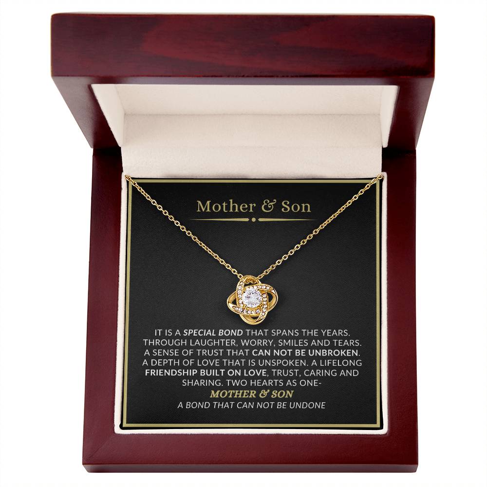 Mother and son love knot gold overlay necklace displayed in luxury mahogany LED gift box