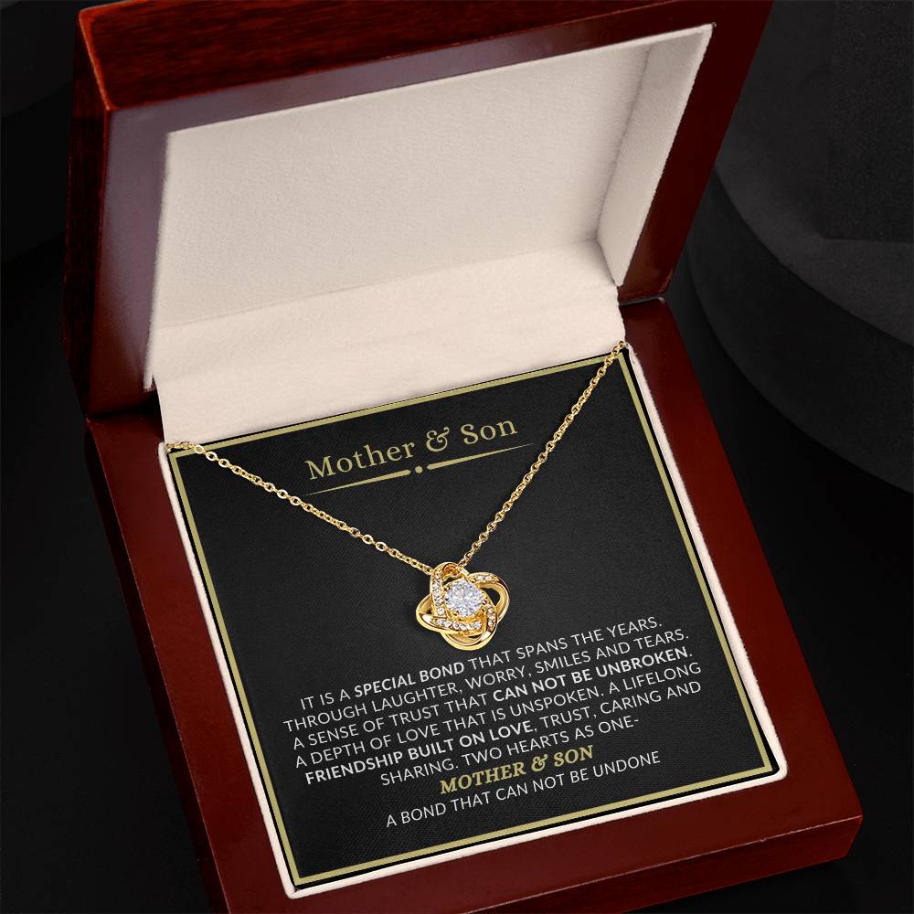 Mother and son love knot necklace displayed in luxury mahogany LED gift box