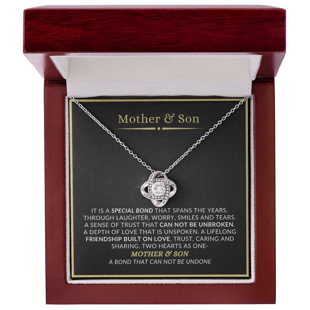 Mother and son love knot necklace displayed in luxury mahogany LED gift box