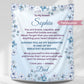 Personalized daughter blanket from Dad in cornflower with blue floral design, hanging against a white wall. 