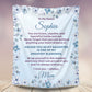 Personalized daughter blanket from Mom in Cornflower with a blue floral design, shown hanging in a cozy room setting.