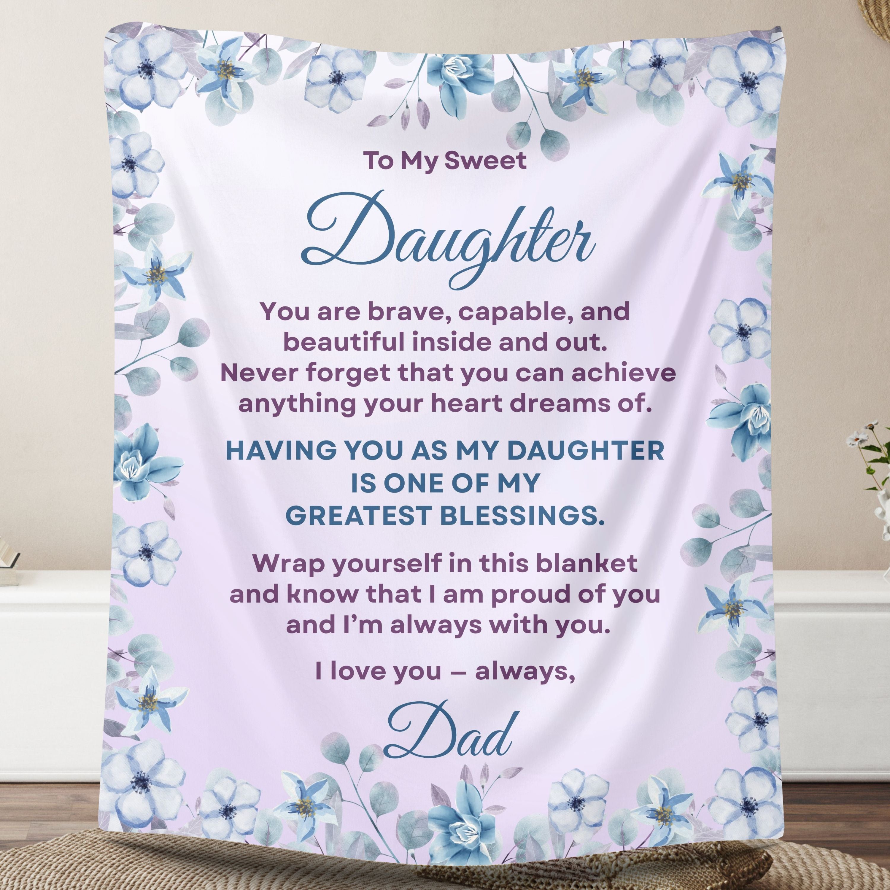 Personalized daughter blanket from Dad in Soft Lavender with a blue floral design, shown hanging in a cozy room setting. 