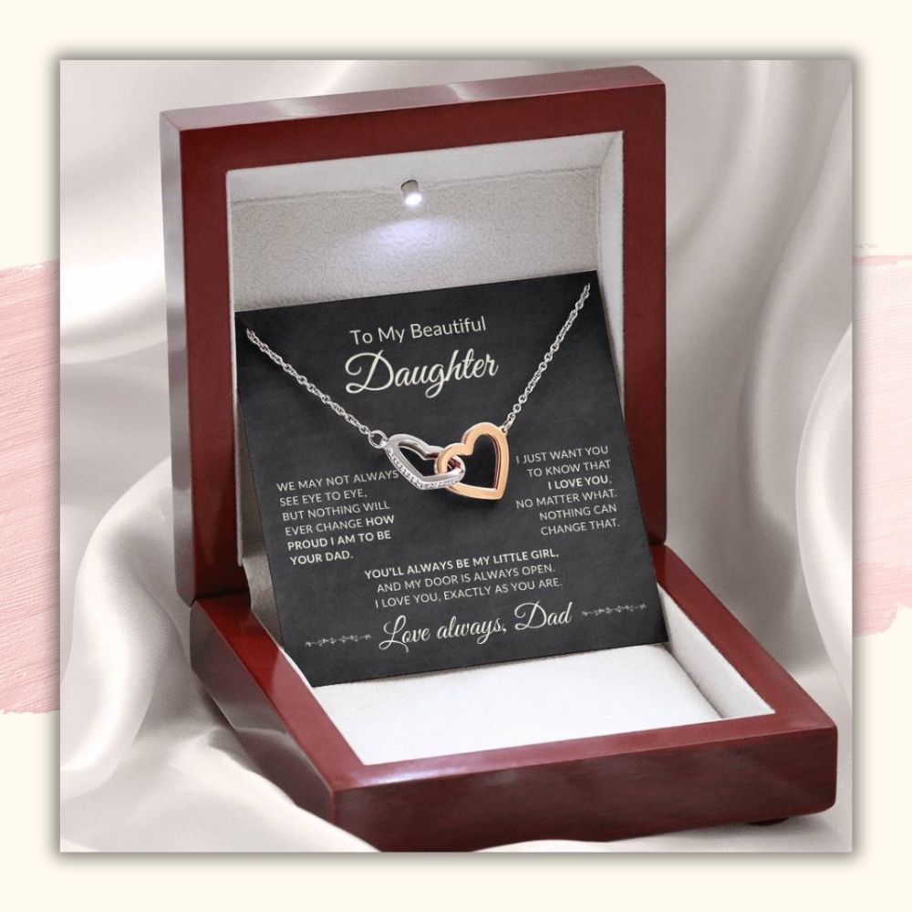 Silver and rose gold interlocking hearts necklace for daughter displayed inside an illuminated mahogany-style luxury gift box with message card from Dad.