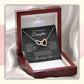 Silver and rose gold interlocking hearts necklace for daughter displayed inside an illuminated mahogany-style luxury gift box with message card from Dad.