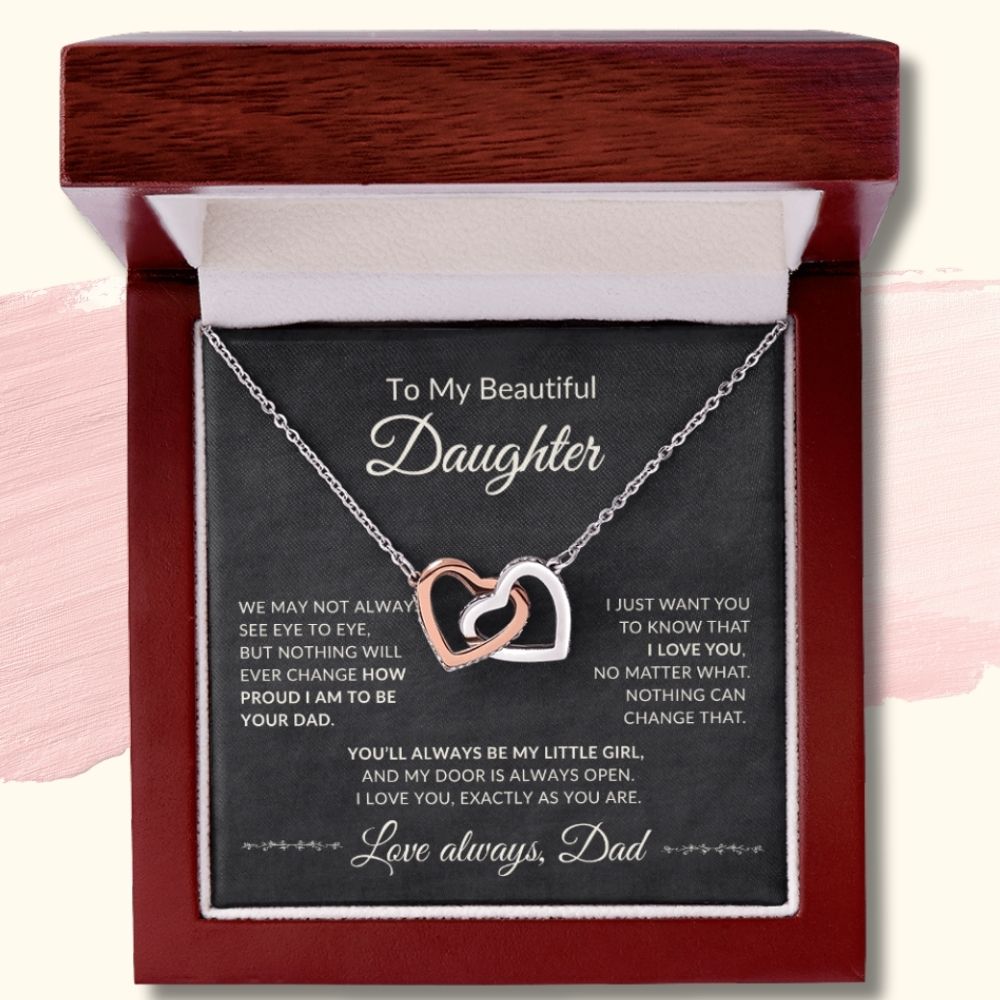 Silver and rose gold interlocking hearts necklace displayed inside a luxury mahogany-style LED gift box with a message card from Dad.