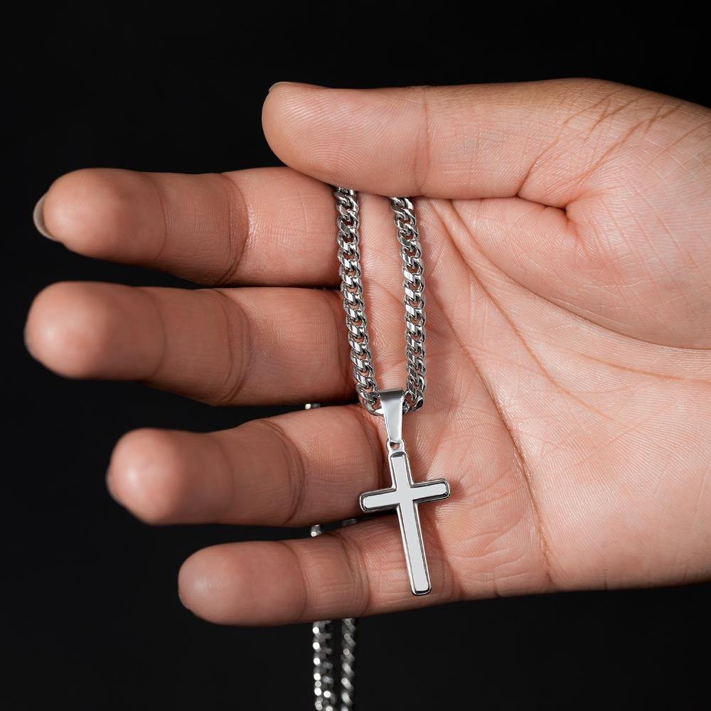 Stainless steel cross necklace for Dad with Cuban chain shown in hand, perfect for Father’s Day or birthday.